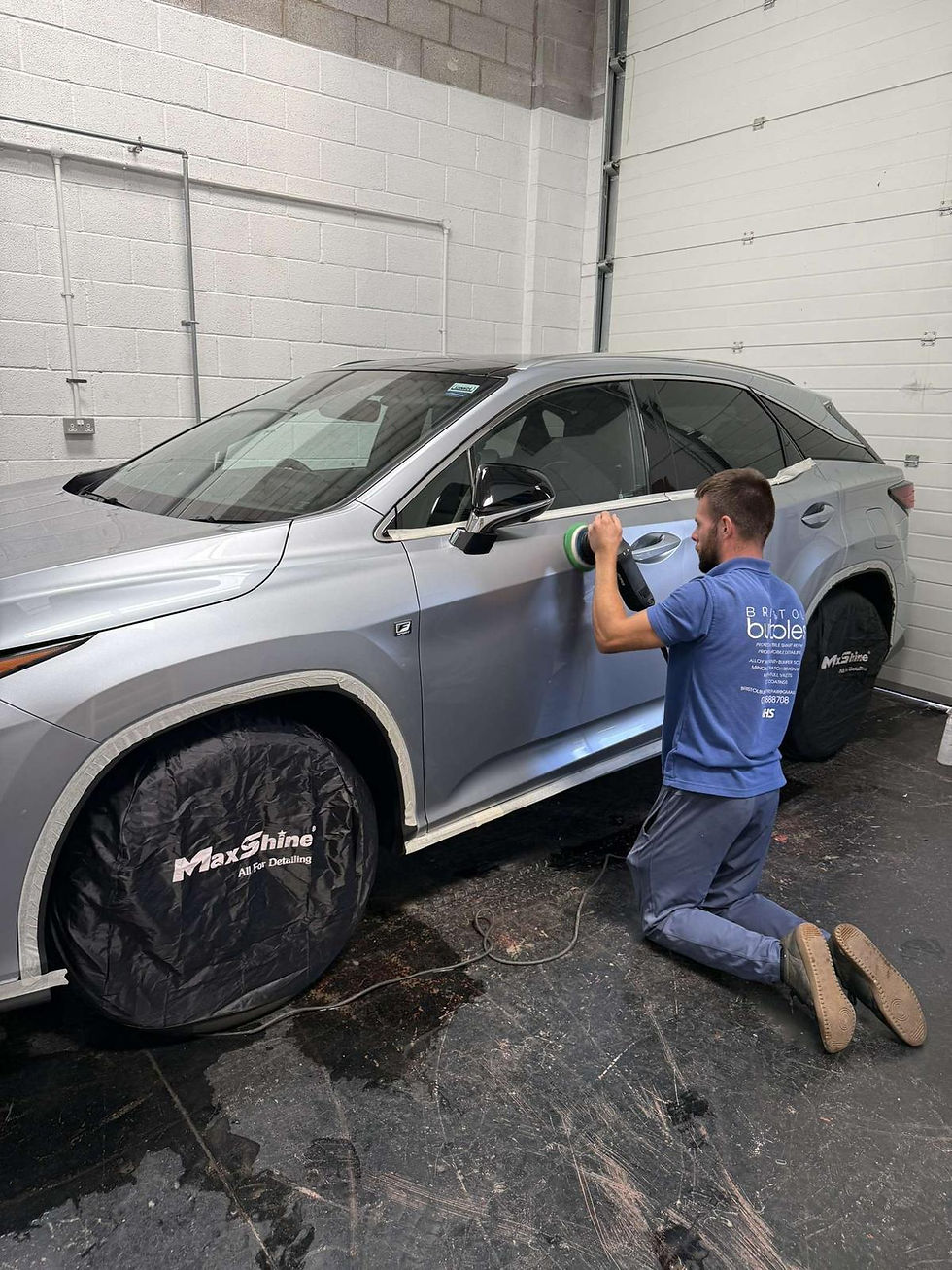Man applying PPF to silver Lexus RX