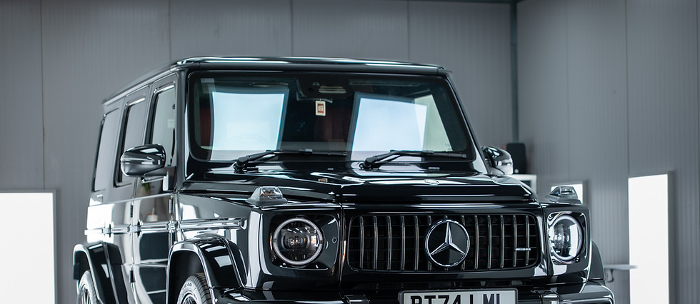 Black Mercedes-Benz G-Class full vehicle in a showroom