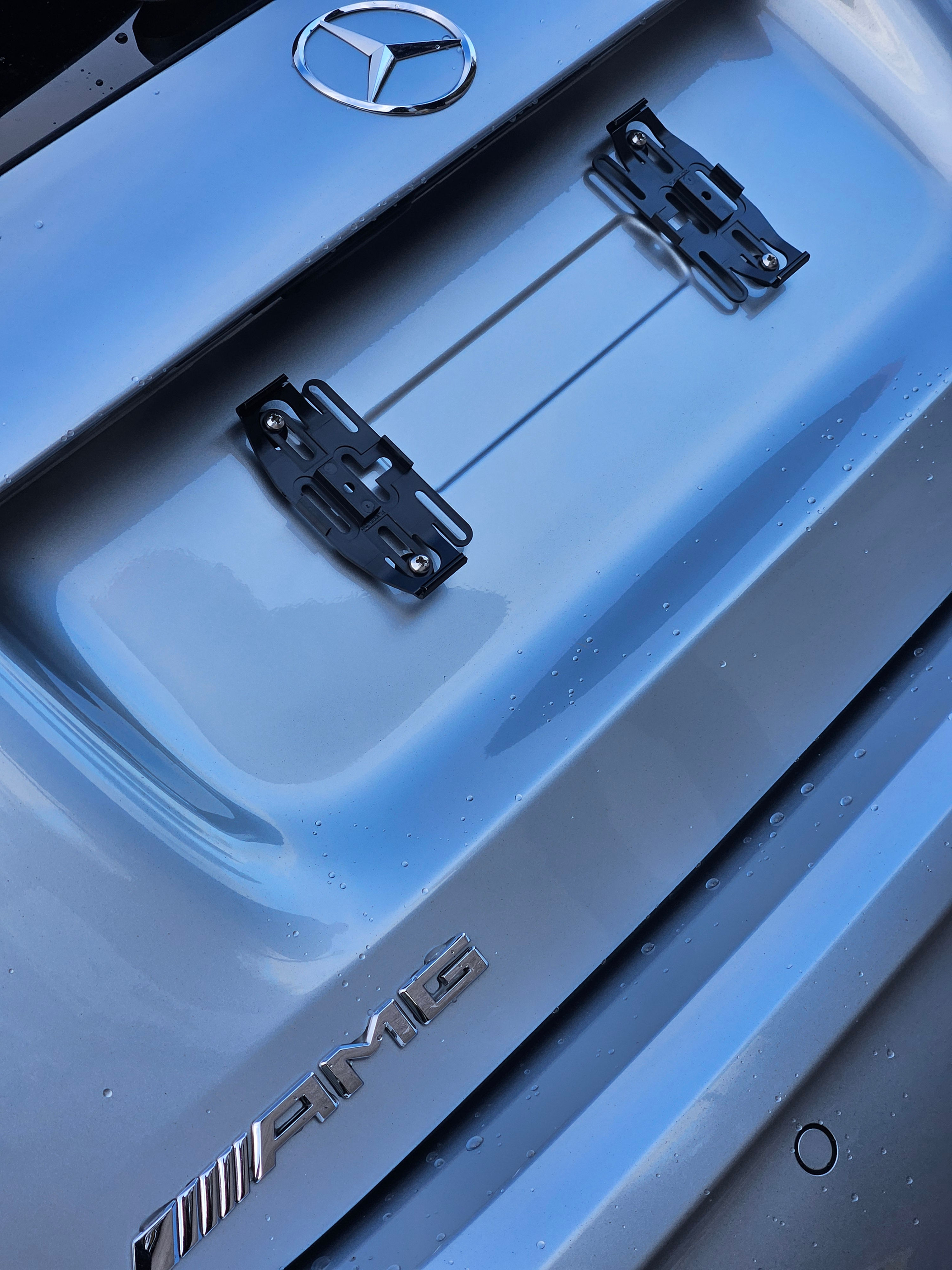 Plexiclip Plate Holder installed on a Mercedes AMG trunk.