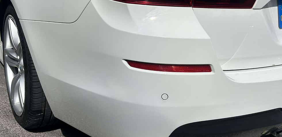 White BMW rear bumper with minor scuffs