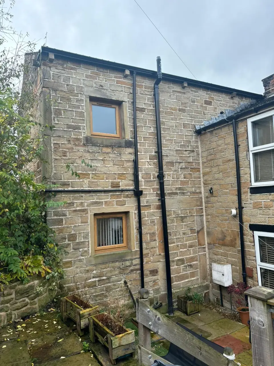 Stone house with new gutters