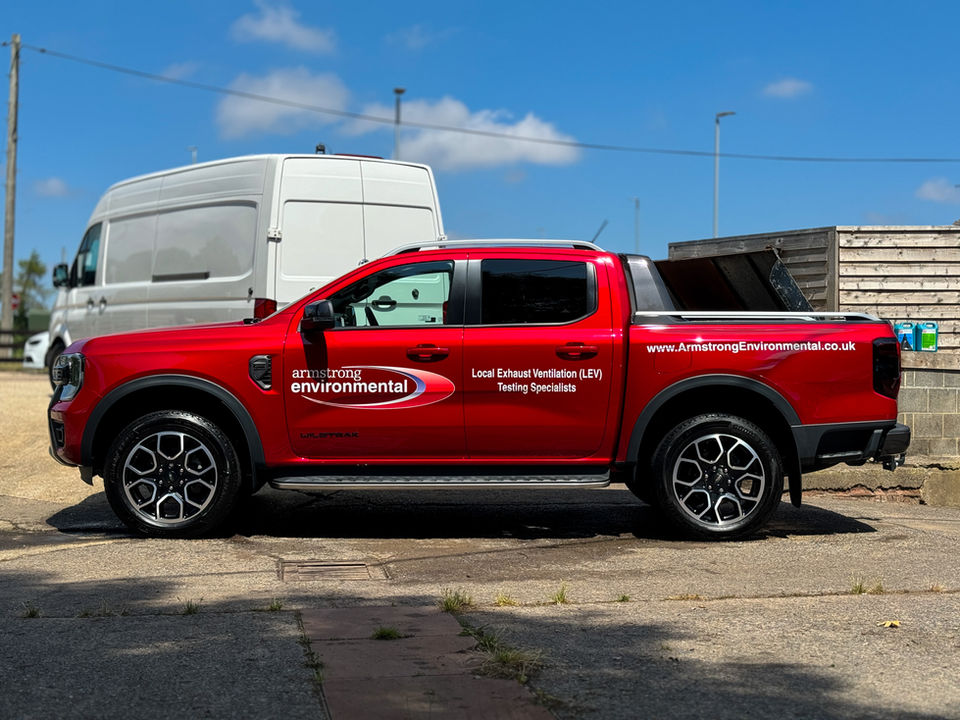 Red truck with JHW Detailing logo and visible text on side.