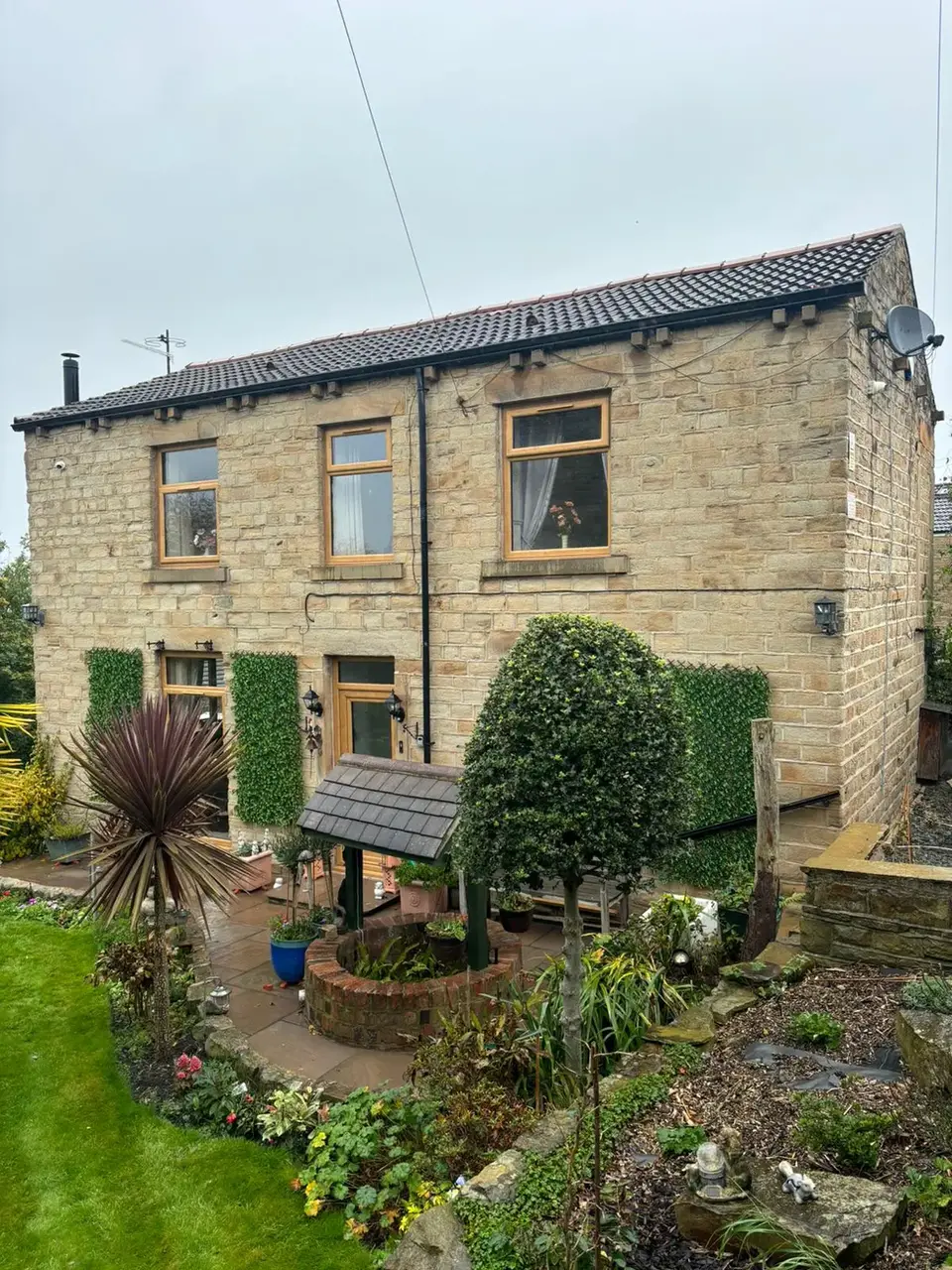 Stone house with green shutters and garden