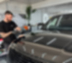 Man polishing dark Range Rover