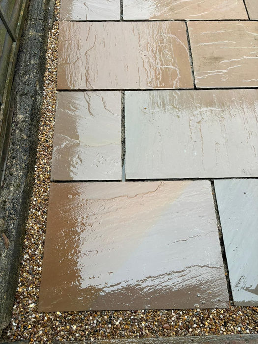 Wet stone patio with gravel border