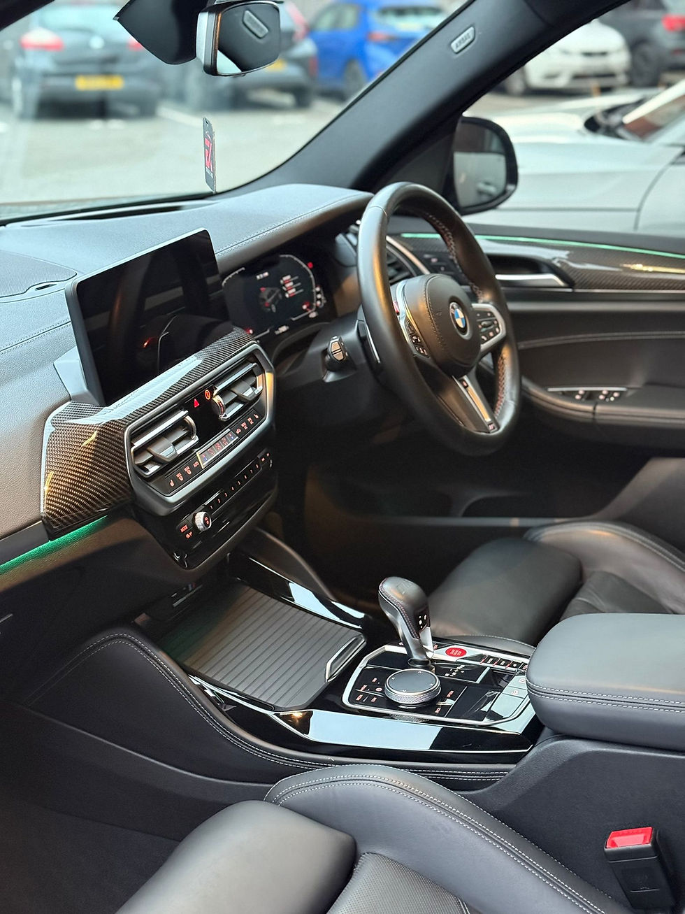 Modern BMW car interior showing dashboard, steering wheel, and central console.