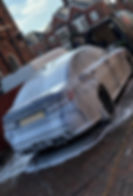 BMW M3 Competition with white snow foam on it.