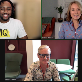 MQ Mental Health research crew in a virtual meeting. One wears a white "MQ" shirt, another a blue shirt with patterns, and the third a floral shirt. Smiling, casual vibe.
