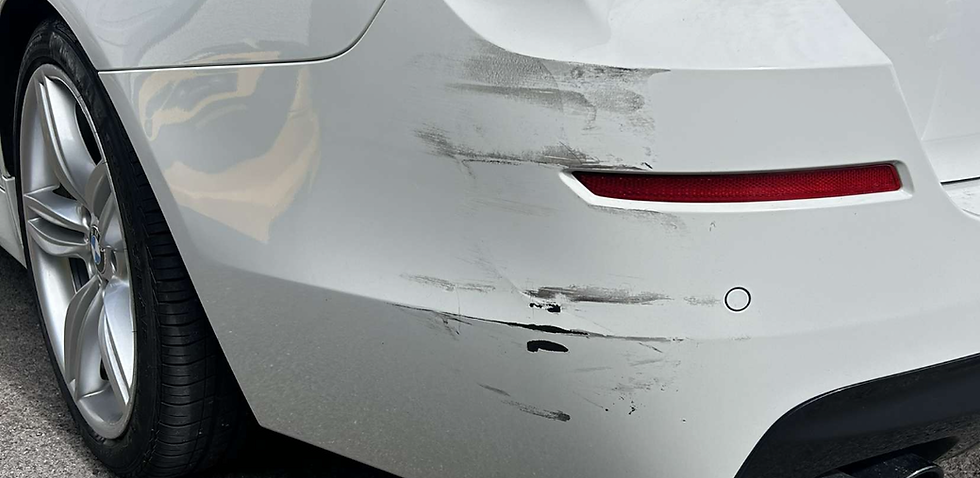 White BMW rear bumper with scratches