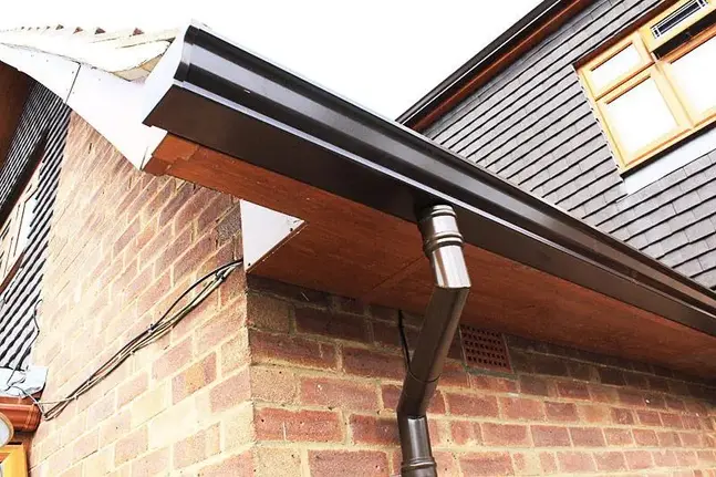 Black seamless gutters on brick house