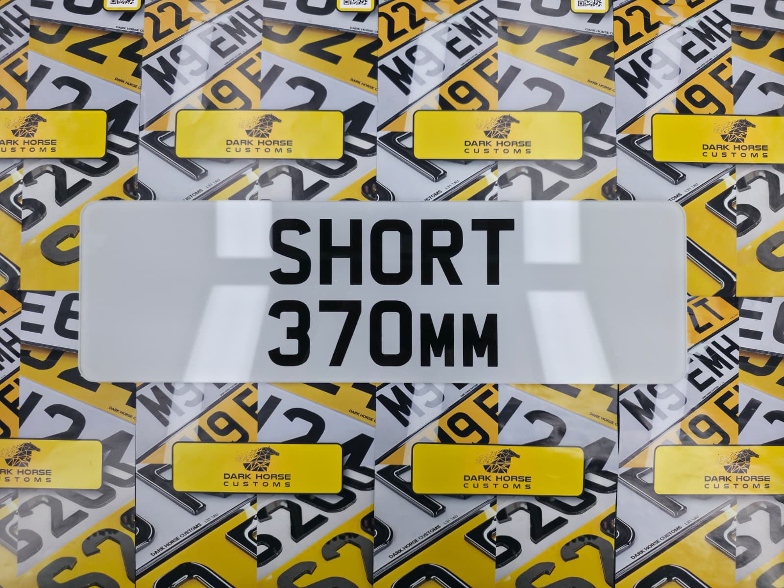 Short 370mm number plate over yellow license plates.