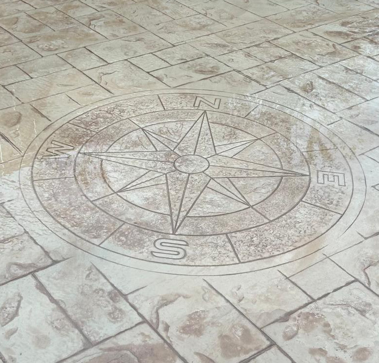 Stamped concrete patio with compass design