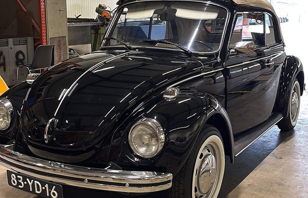 Classic black Volkswagen Beetle vintage car at the Zuuring Car Care studio in Heteren, showcasing specialist restoration and detailing services for historic and heritage vehicles.