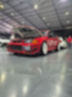 Red Mitsubishi Lancer Evolution, license plate BL7Z, at car show