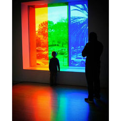 A small boy pauses and views the world in another color, a beauty neither of us can explain