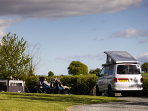 Relaxing couple enjoying an afternoon peace looking at views over Ingleborough