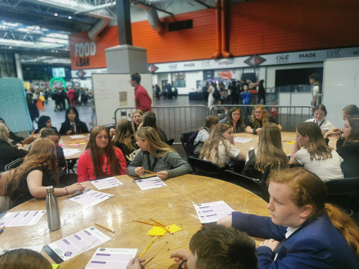 Students sit around a table with smart revision worksheets for exam prep