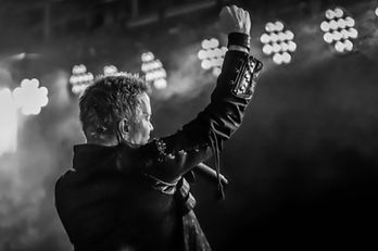 Matthew Eberhart of Idol X lead singer raising a fist during a concert