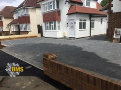 Brick front wall and block paving double driveway shared access