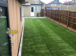 Garden landscaping - Indian sandstone patio, turf, fence and garden office outbuilding