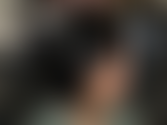 A woman with smooth, jet-black layered hair styled into a soft, modern bob with light face-framing pieces, photographed inside Flaunt Salon in Round Rock, Texas. The salon’s red diamond-patterned wall and stylish interior are visible in the background, highlighting the salon’s clean, elevated atmosphere.