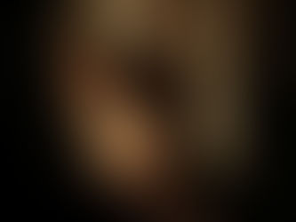 A close-up of the back of a woman’s head with blonde hair pulled into a ponytail, showing soft highlights and natural dimension against a dark background.