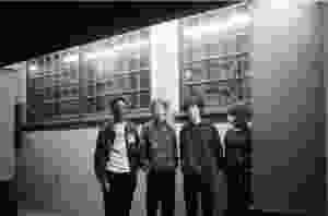 A black and white image of the four members of the band "Not From England"