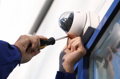 Ranger technician installing a security camera