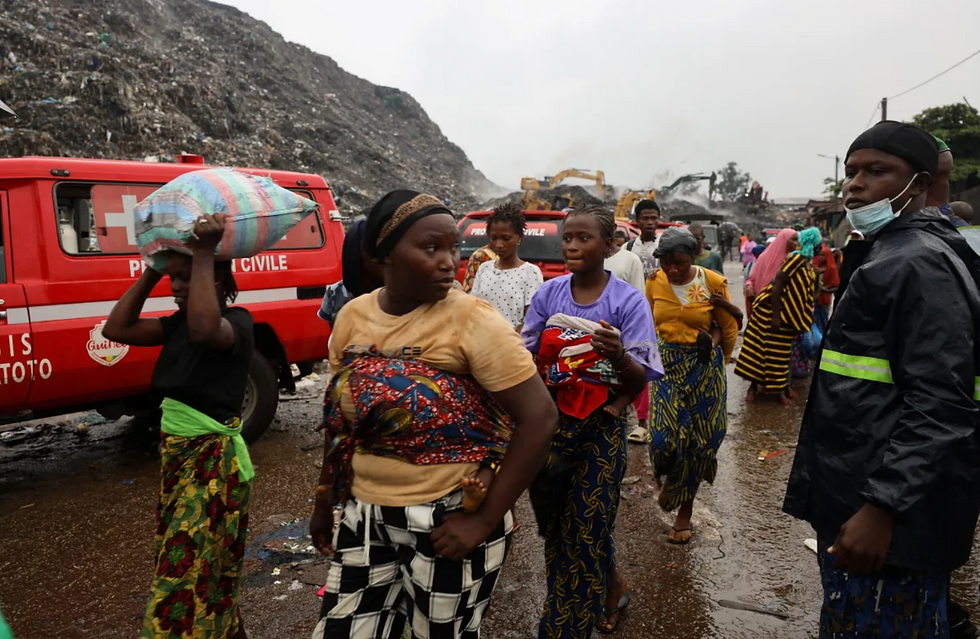 Residents living near the landfill in Dar es Salam in Conakry leave their homes after the landslide triggered by heavy overnight rain. File Photo: Souleymane Camara/Reuters.