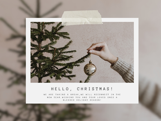 An image of a hand holding up a gold christmas ornament. 