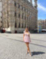 Travel blogger standing in front of ornate Gothic Leuven Town Hall in Belgium