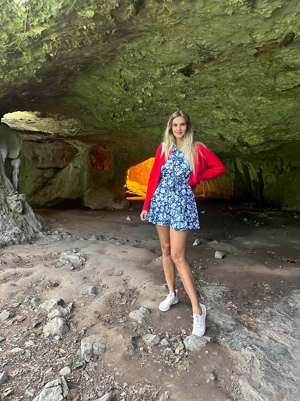 Natalija Ugrina standing inside the Zugarramurdi Witches’ Cave, surrounded by ancient rock formations.