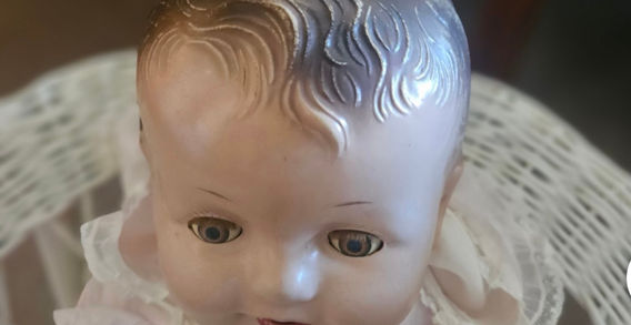 A close up of a doll head