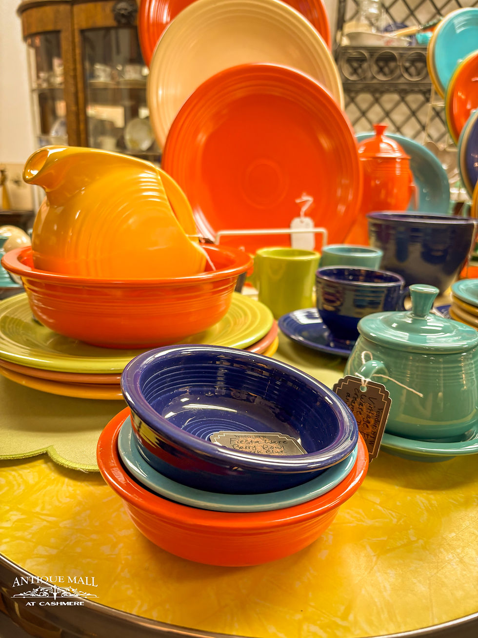 Colorful fiesta ware sits on a table.