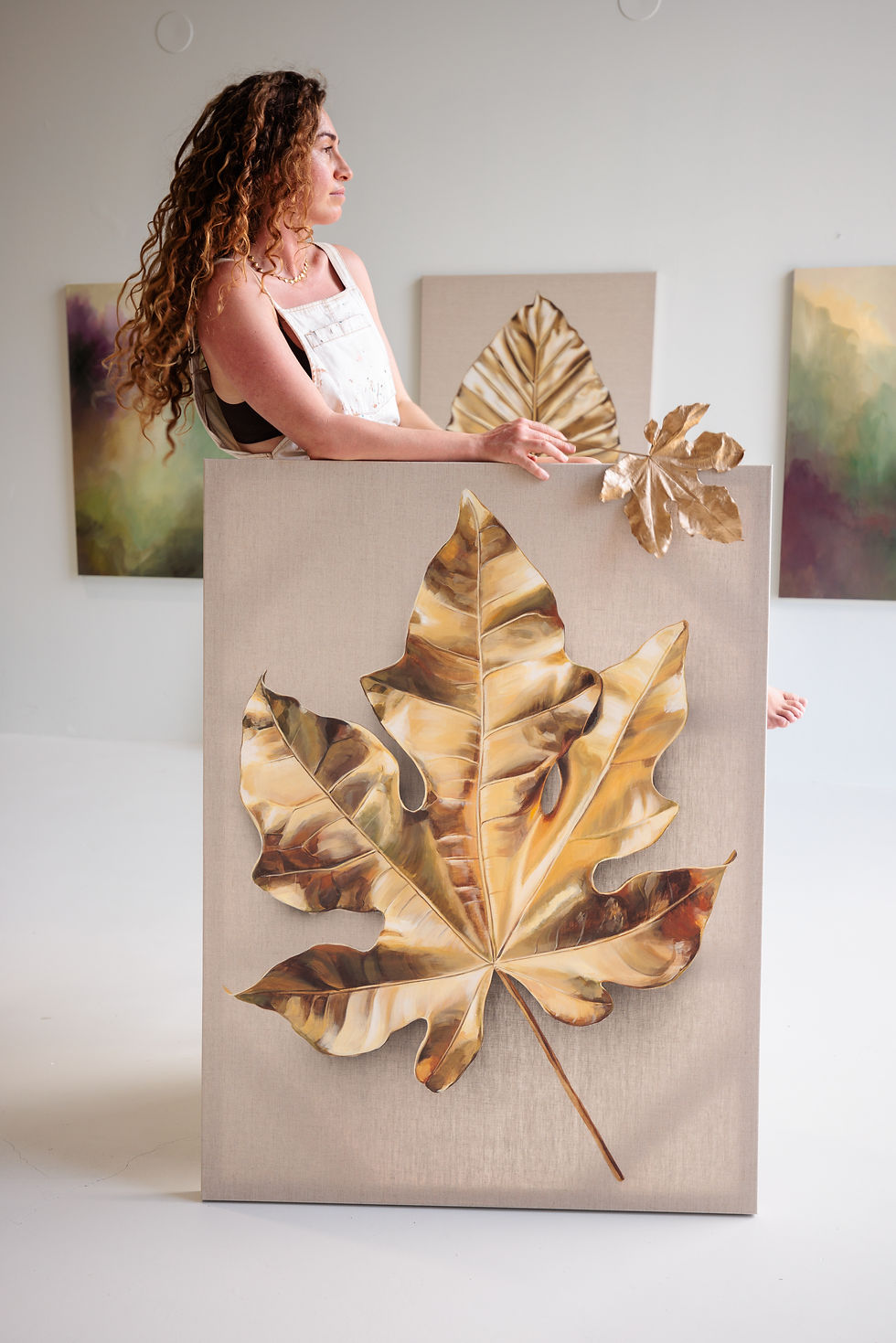 Close up of completed large-scale gold leaf Monstera painting by Rosie Woods.