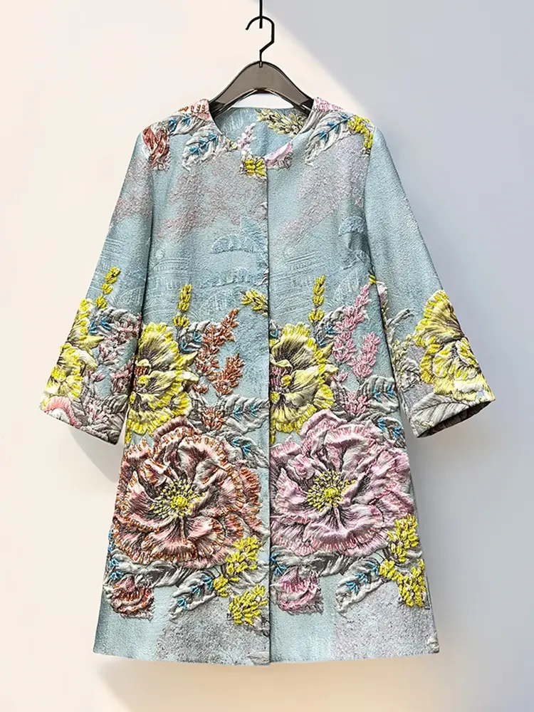 Floral embroidered coat in pastel blue with pink, yellow, and gold accents, hanging on a hanger.