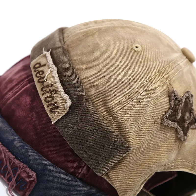 Miniaturebillede: Stack of vintage caps in varied colors, featuring distressed patches and adjustable straps.