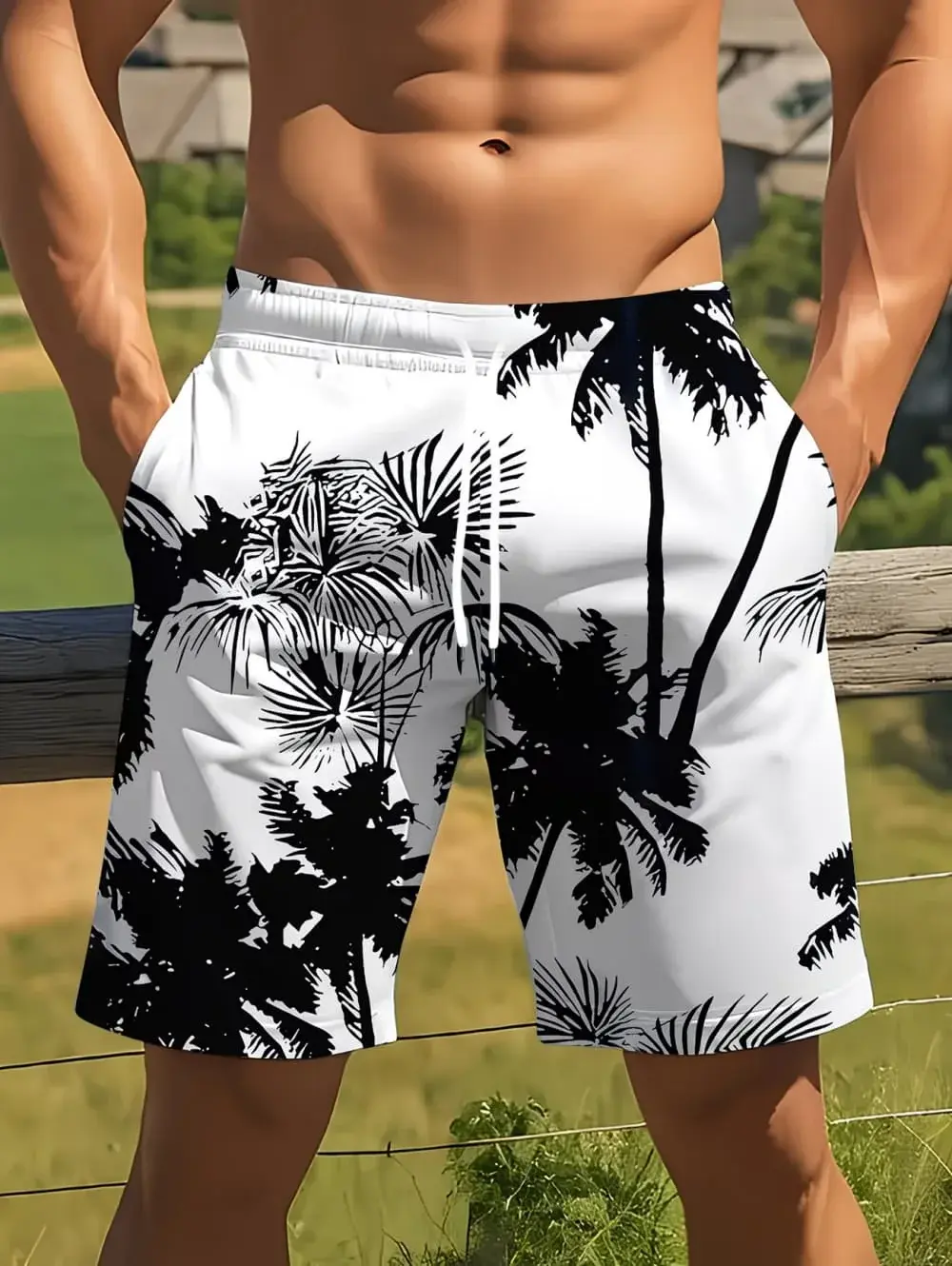 Man in white shorts with black palm tree print, standing outdoors near a wooden fence.
