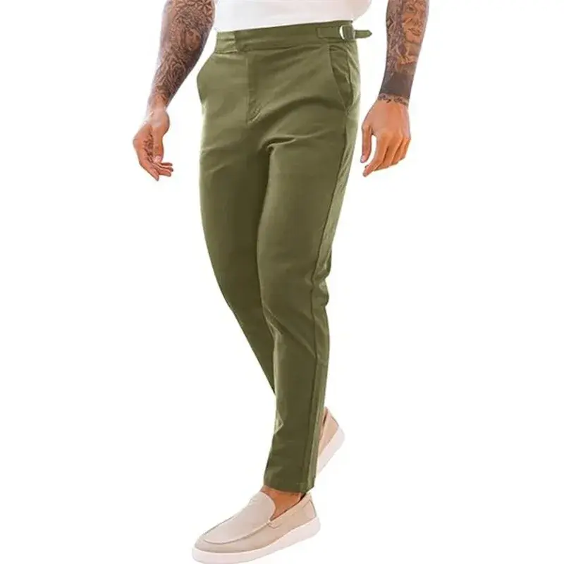 Thumbnail: Man in beige pants and loafers with tattoos on arms, wearing a white top, standing against a white background.