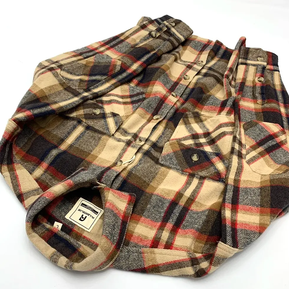 Tan, red, and navy plaid flannel shirt with dual chest pockets and buttoned cuffs on a white background.
