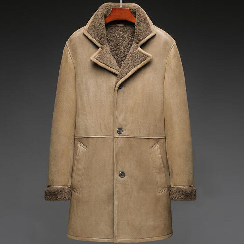 Tan shearling coat with a soft, textured lining, two buttons, and pockets. Dark background highlights the coat's details.