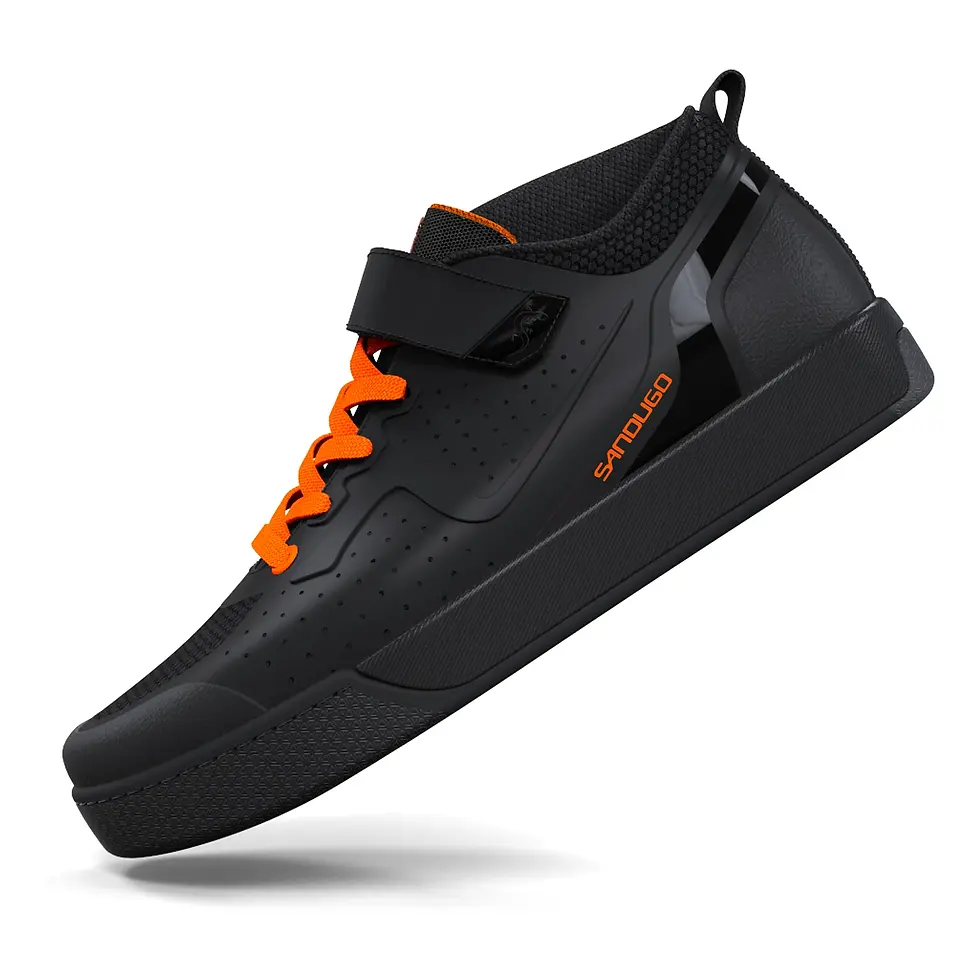 Black athletic shoe with orange laces, Velcro strap, and textured sole, featuring a sleek design and perforated details.