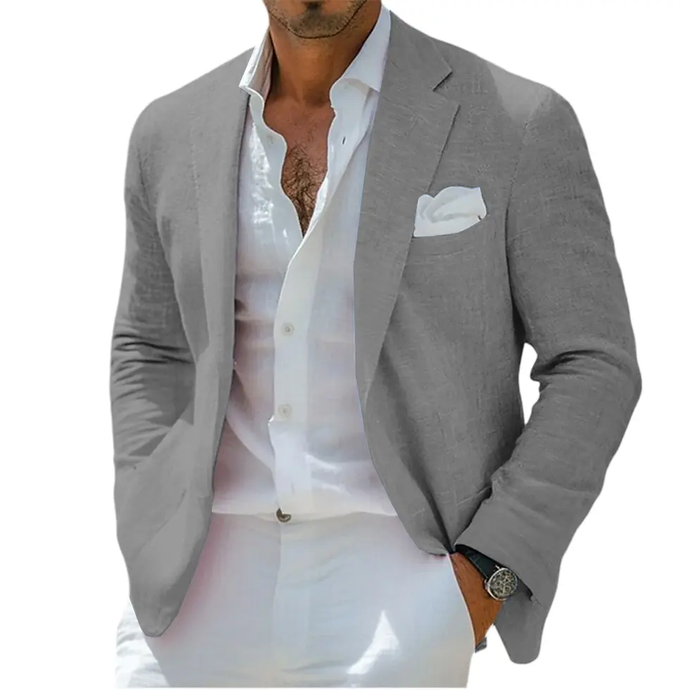 Thumbnail: Man in a tan suit jacket with a white shirt and pants, wearing a watch, standing outdoors with greenery in the background.