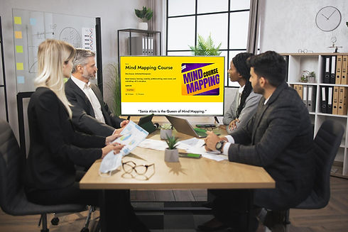 Corporate team in a meeting room using Futuristic Learning's mind mapping course on a screen, representing team growth through online business training