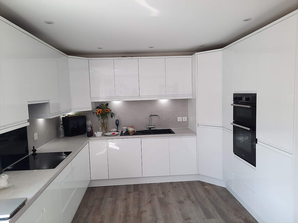 High‑gloss J‑pull kitchen in Moray with seamless handleless doors, reflective lacquer finish, and a clean modern layout.