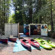 Canoes and kayaks outside of the Paddle Pod - Pristine Paddleboard Adventures