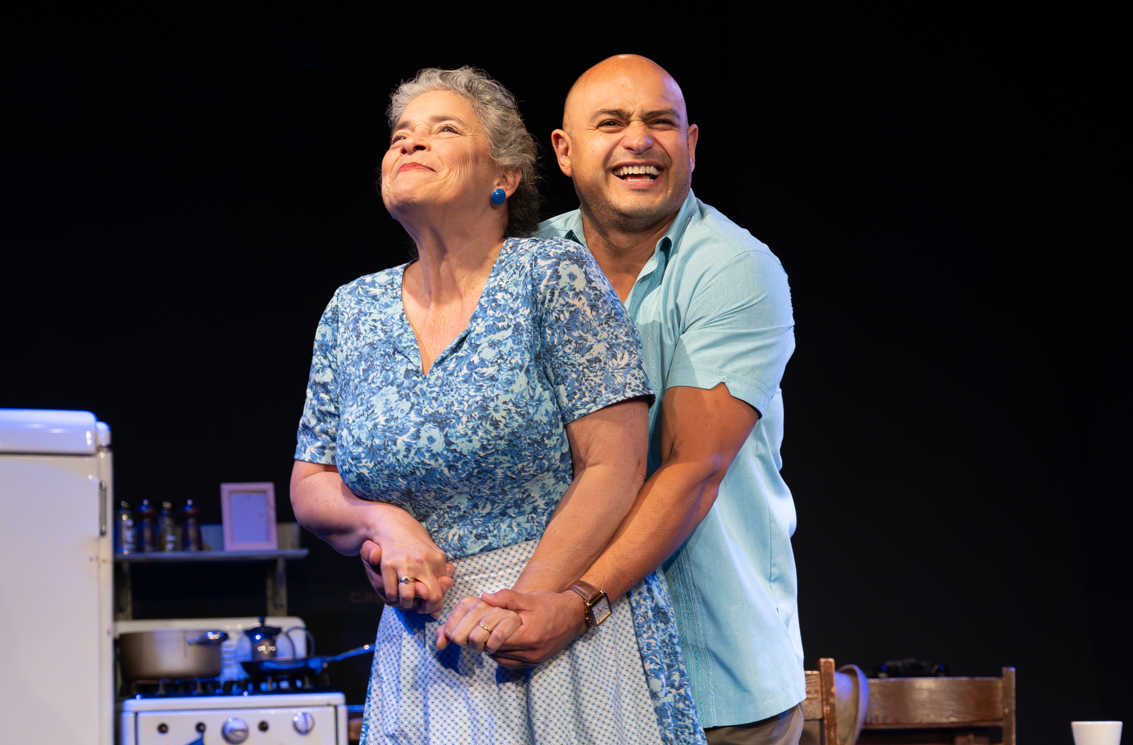 A man and a woman hugging and smiling