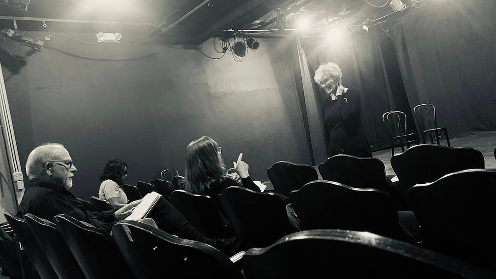 an actor on stage recieving notes from a director