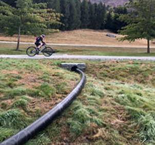 The pipeline carrying sediment from the ponds to the collection and filtering bag.
