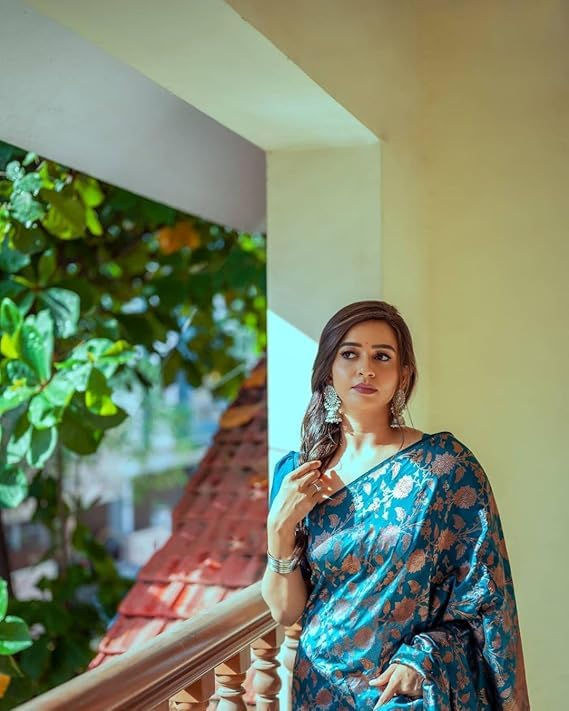 Thumbnail: Woman wearing Women's Chiffon Ethnic Motifs Printed Saree with Blouse Piece on balcony.